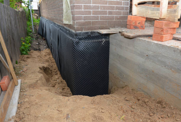 Happy homeowners after waterproofing job in Jericho